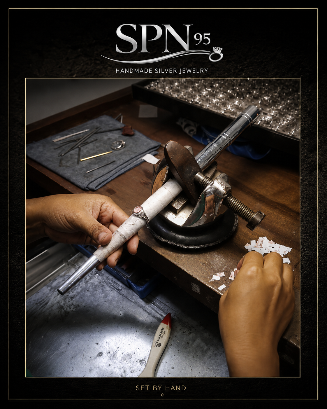 SPN 95 stone setter placing a colored gemstone into a silver ring under the loupe